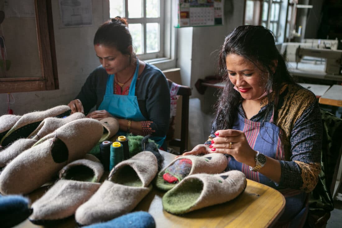 Two craftswomen from the Federation of Women Entrepreneur Association Nepal (FWEAN) in their workshop producing felt items.