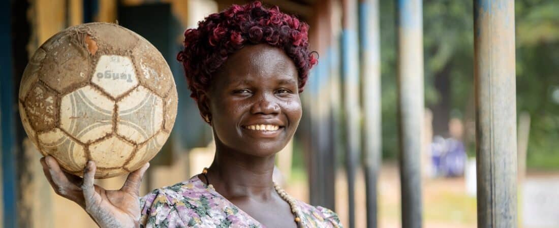 Josephine, a teacher, stands outside Rodo Primary School in Obongi, Uganda. Photo credit: Rich Townsend, AKFC