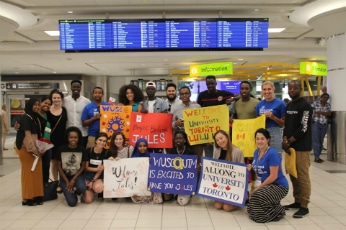 Students await the arrivals of their peers at Pearson Airport
