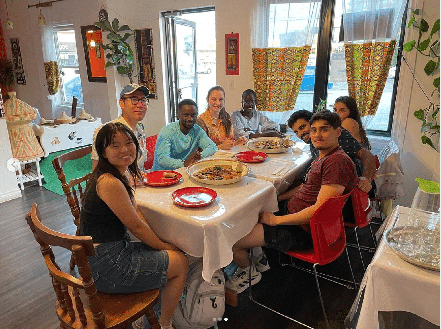 A group of friends gather around a table.