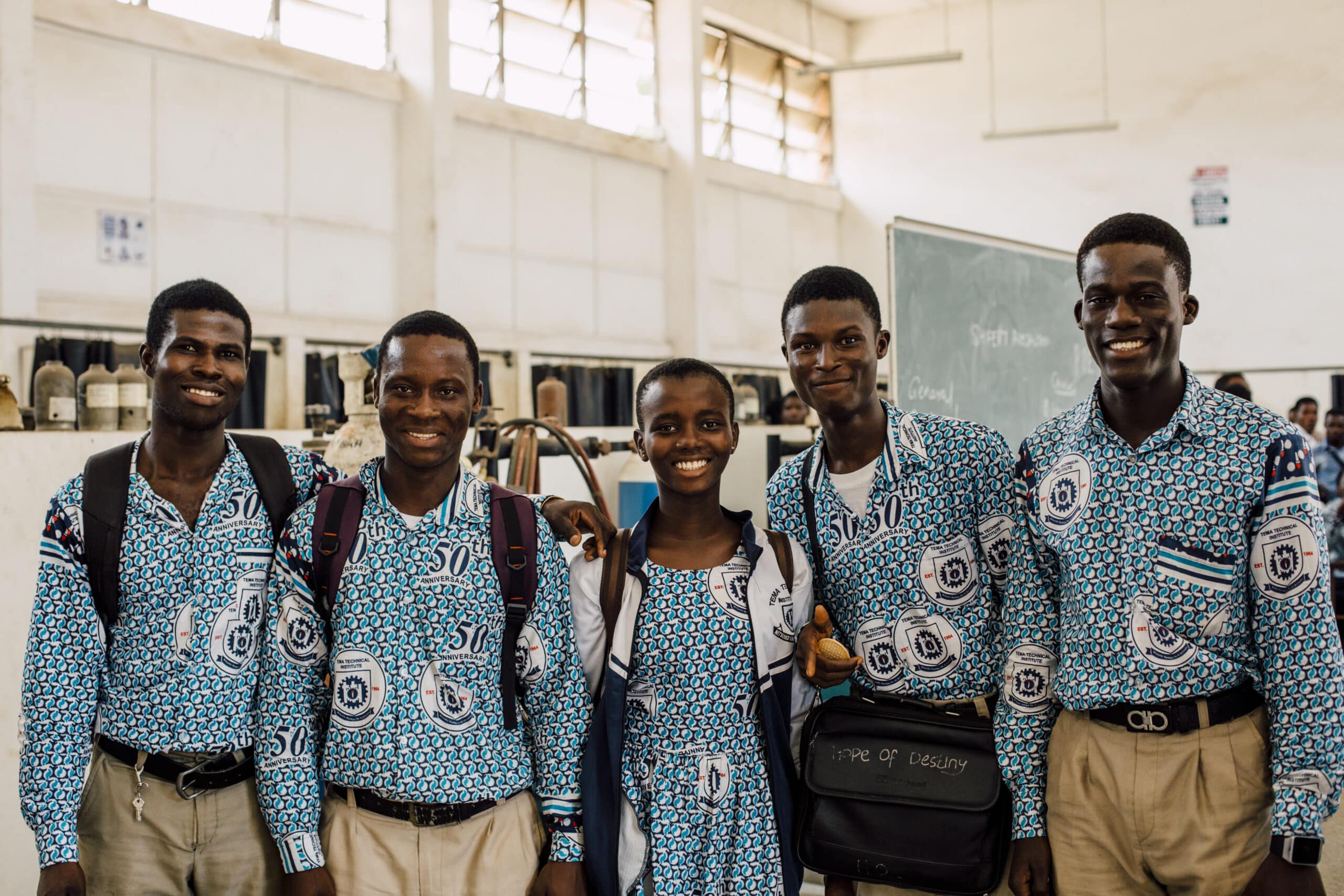 A group of students pose for a photo inside their classroom in Ghana.